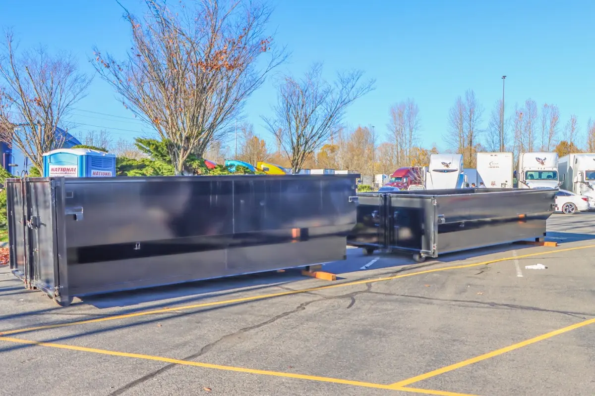 Professional dumpster rental service with roll-off container on residential driveway in Darien